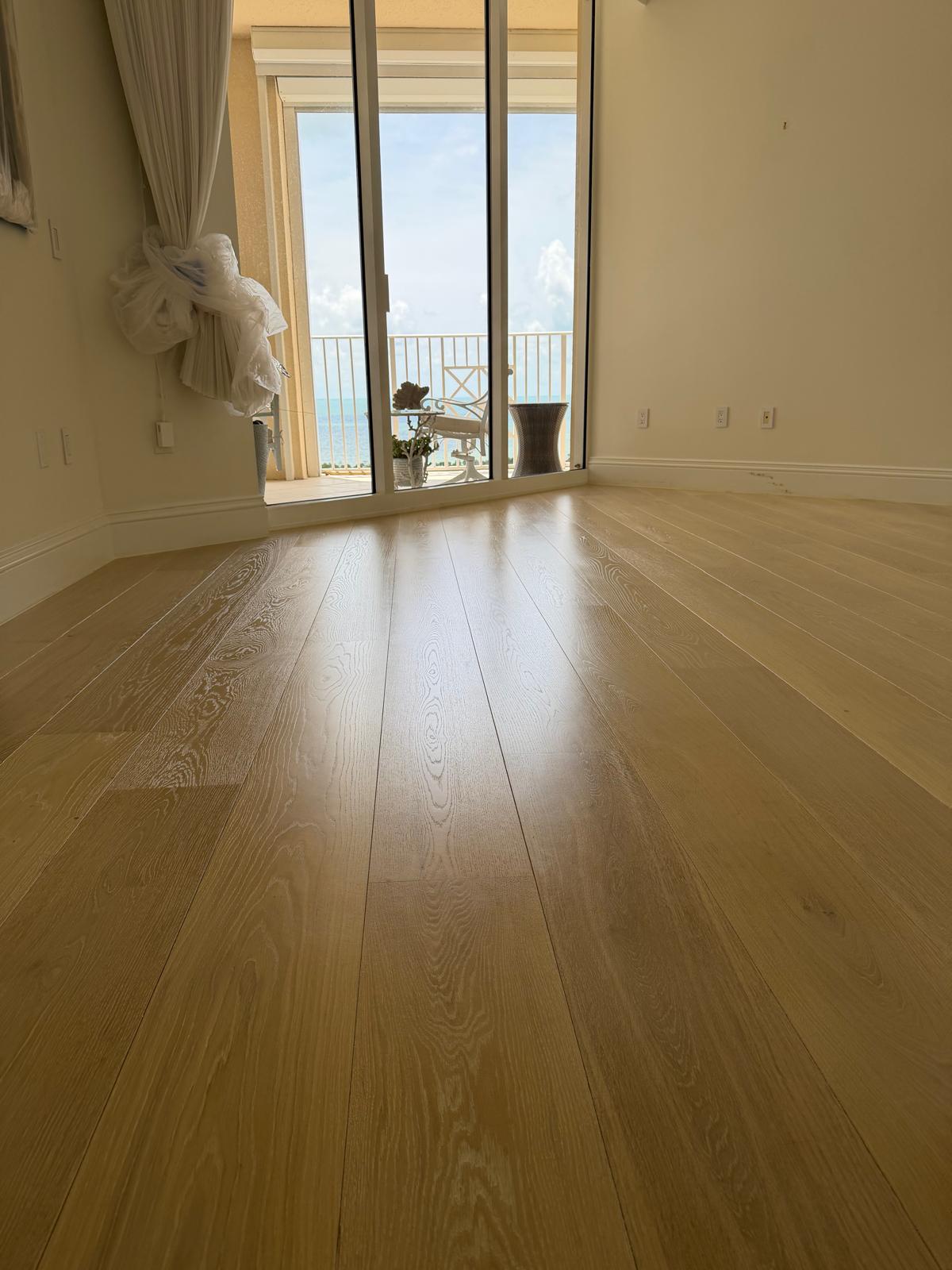 Freshly finished wide-plank oak floor in a Naples beachfront condo by Topline Flooring