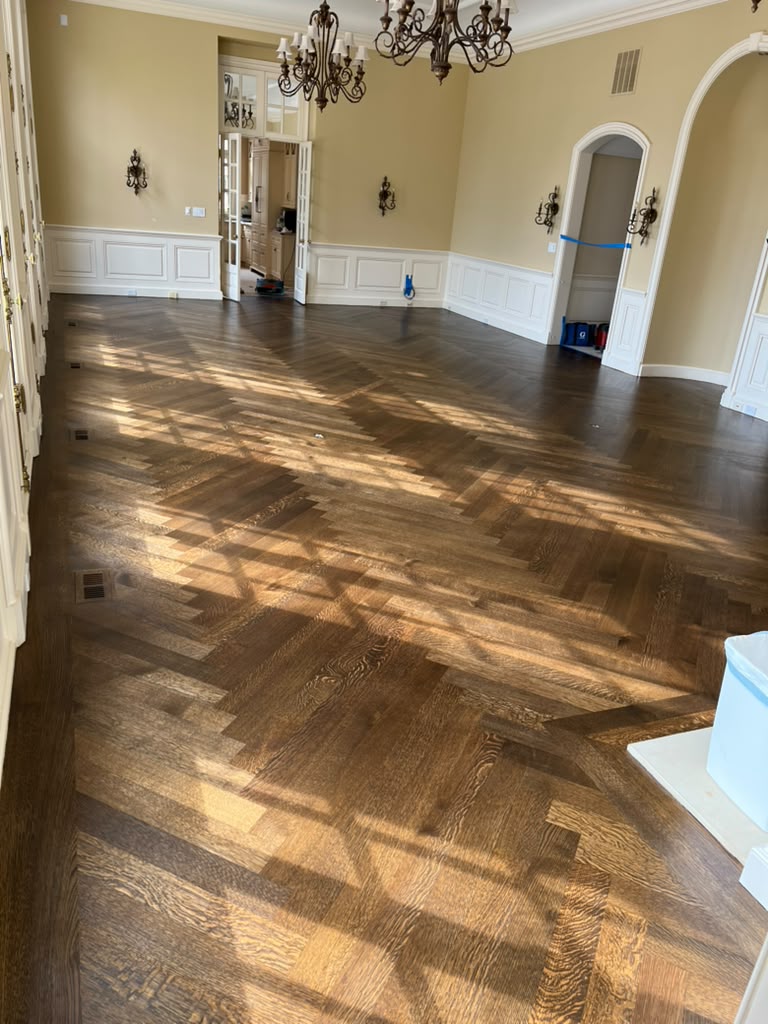 Herringbone hardwood floor after custom staining and finishing by Topline Flooring
